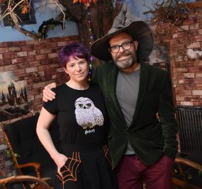 Rob and Nikki in front of a wizard-inspired display